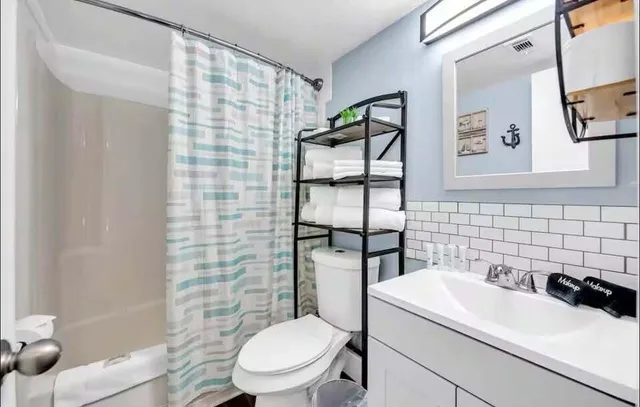 a white toilet sitting next to a bathroom sink
