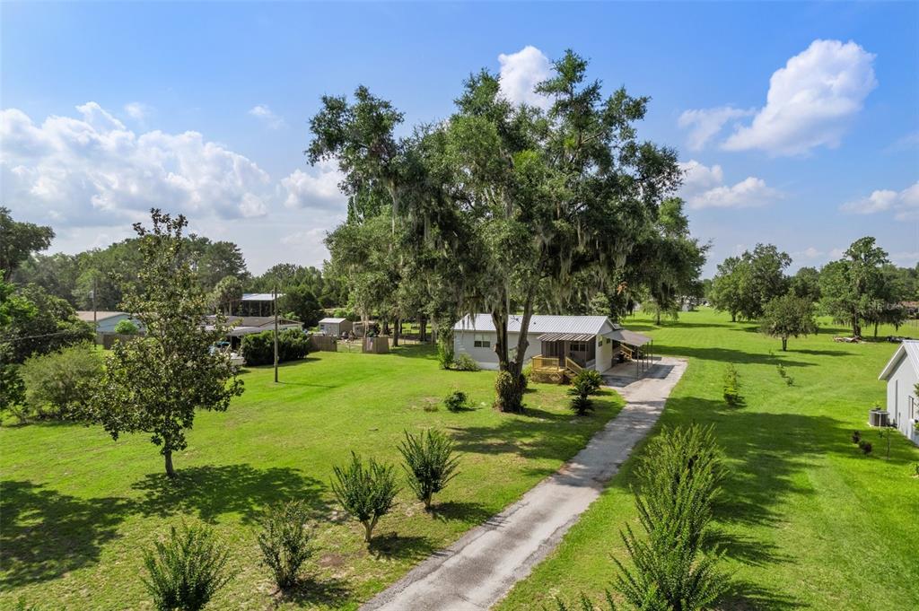 View from the street, house set back w/ nice long driveway