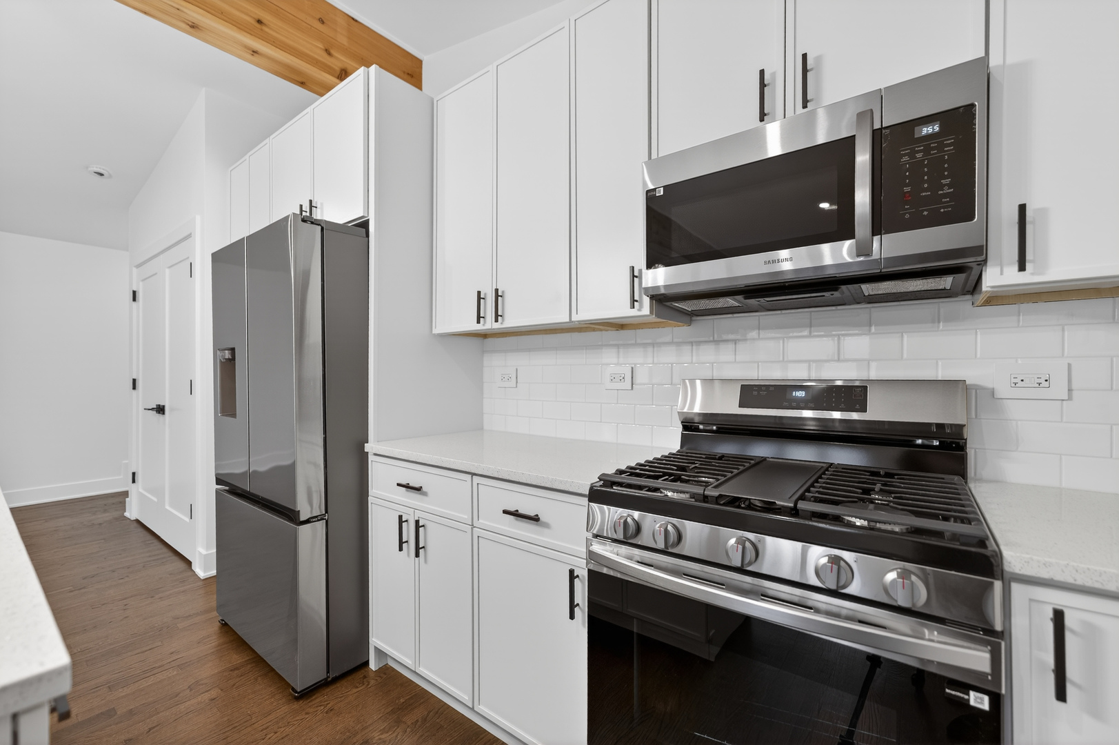 241 East Schick Road Bloomingdale, IL 60108 - Photo 11 of 30 a kitchen with stainless steel appliances a refrigerator stove and microwave