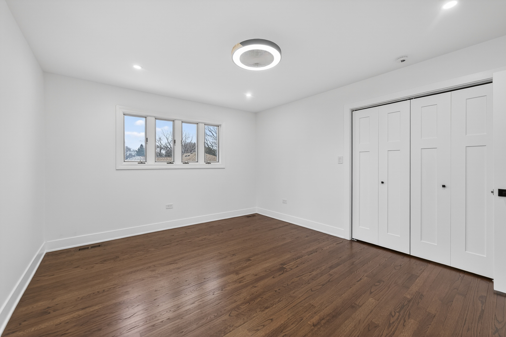 241 East Schick Road Bloomingdale, IL 60108 - Photo 16 of 30 a view of empty room with wooden floor and fan