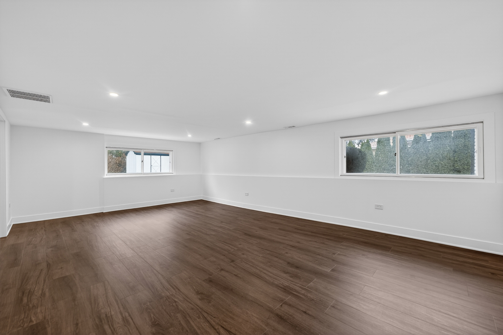 241 East Schick Road Bloomingdale, IL 60108 - Photo 21 of 30 a view of an empty room with wooden floor and a window