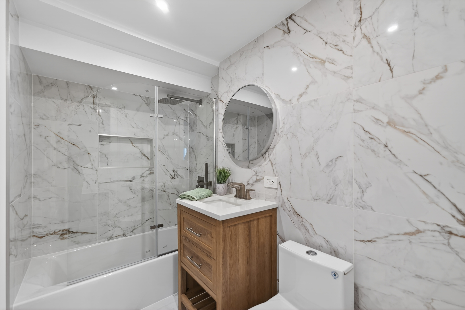 241 East Schick Road Bloomingdale, IL 60108 - Photo 23 of 30 a bathroom with a sink toilet and shower