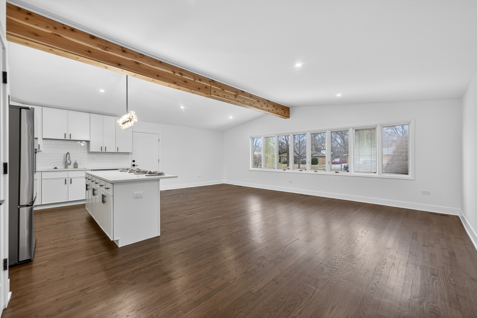 241 East Schick Road Bloomingdale, IL 60108 - Photo 5 of 30 a kitchen with a wooden floor and white cabinets