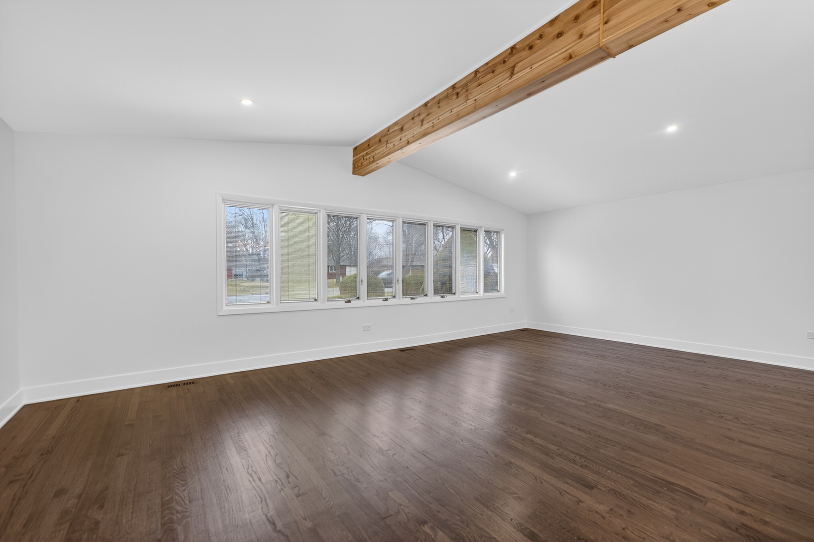 241 East Schick Road Bloomingdale, IL 60108 - Photo 7 of 30 a view of an empty room with wooden floor and a window