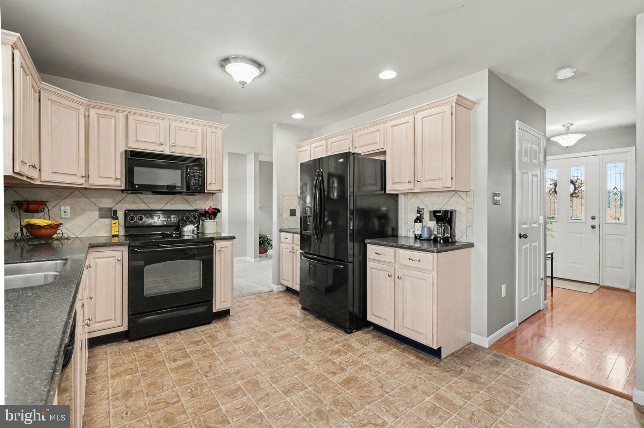 44 Oak Avenue Halifax, PA 17032 - Photo 12 of 33 a kitchen with a refrigerator stove and white cabinets