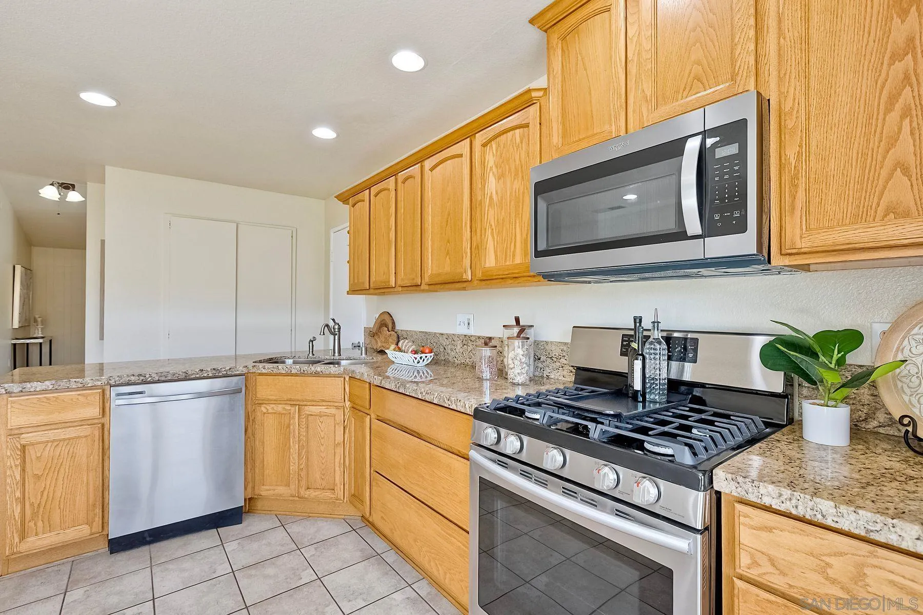 13440 Montego Drive Poway, CA 92064 - Photo 14 of 35 a kitchen with a stove a sink and a microwave