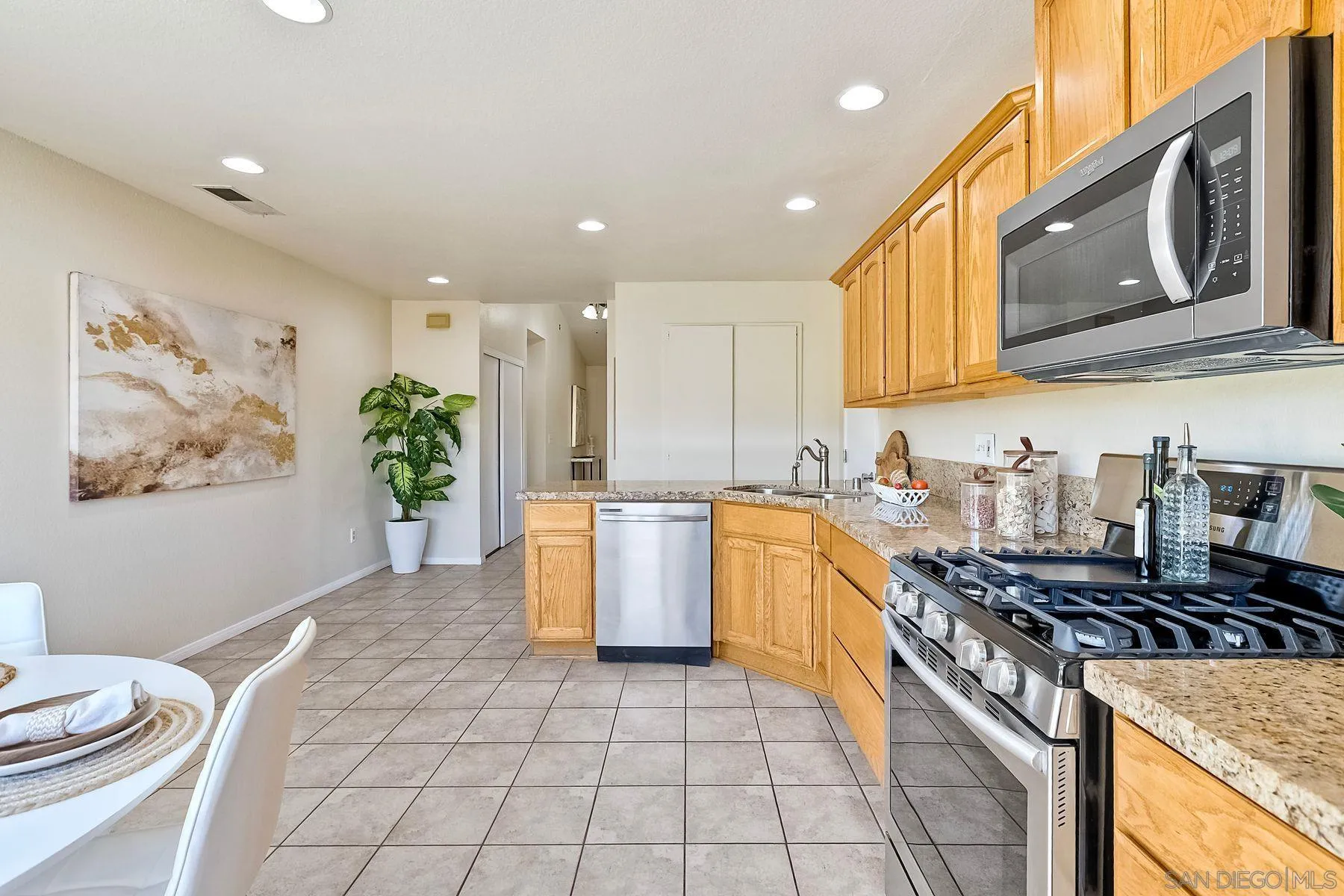 13440 Montego Drive Poway, CA 92064 - Photo 15 of 35 a kitchen with a sink stove and cabinets