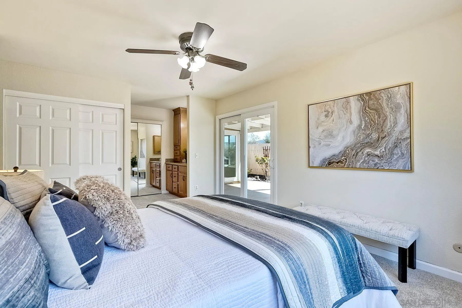 13440 Montego Drive Poway, CA 92064 - Photo 26 of 35 a bedroom with a bed and a chandelier
