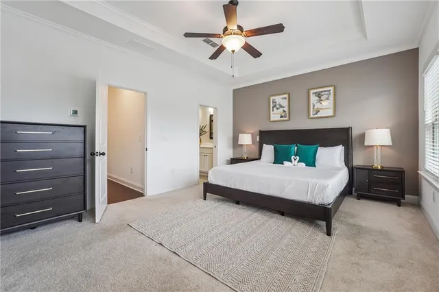 a bedroom with a large bed and a chandelier