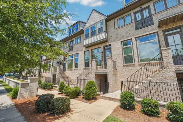 a front view of a brick house with a yard