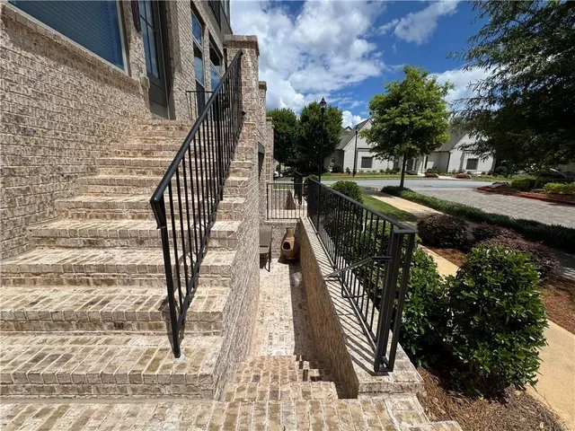 a view of a patio with dining table and chairs