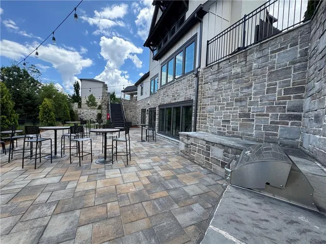 a view of a patio with a table and chairs