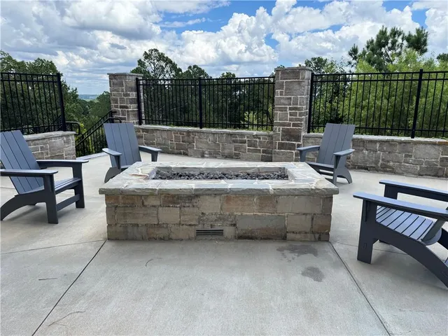 a view of swimming pool with outdoor seating and yard in back