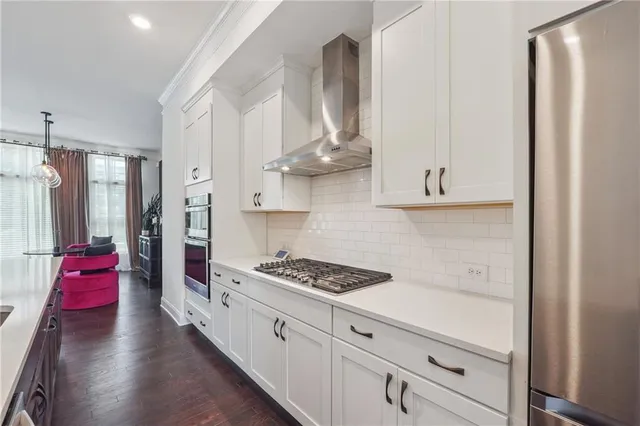 a large kitchen with sink a refrigerator and windows