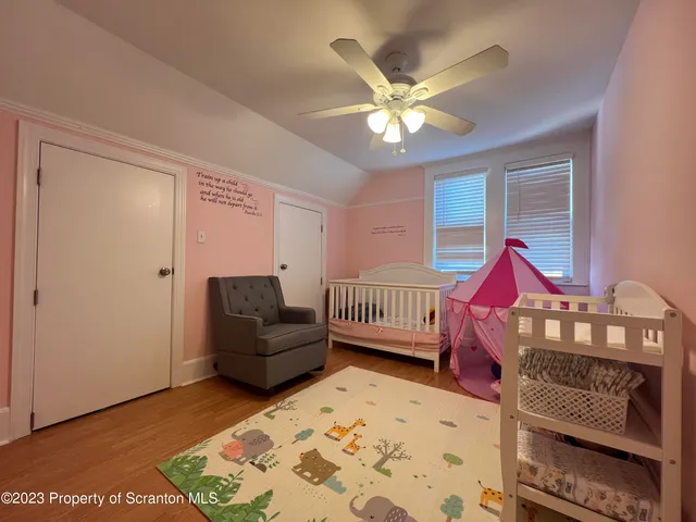 a living room with a bed furniture and a window
