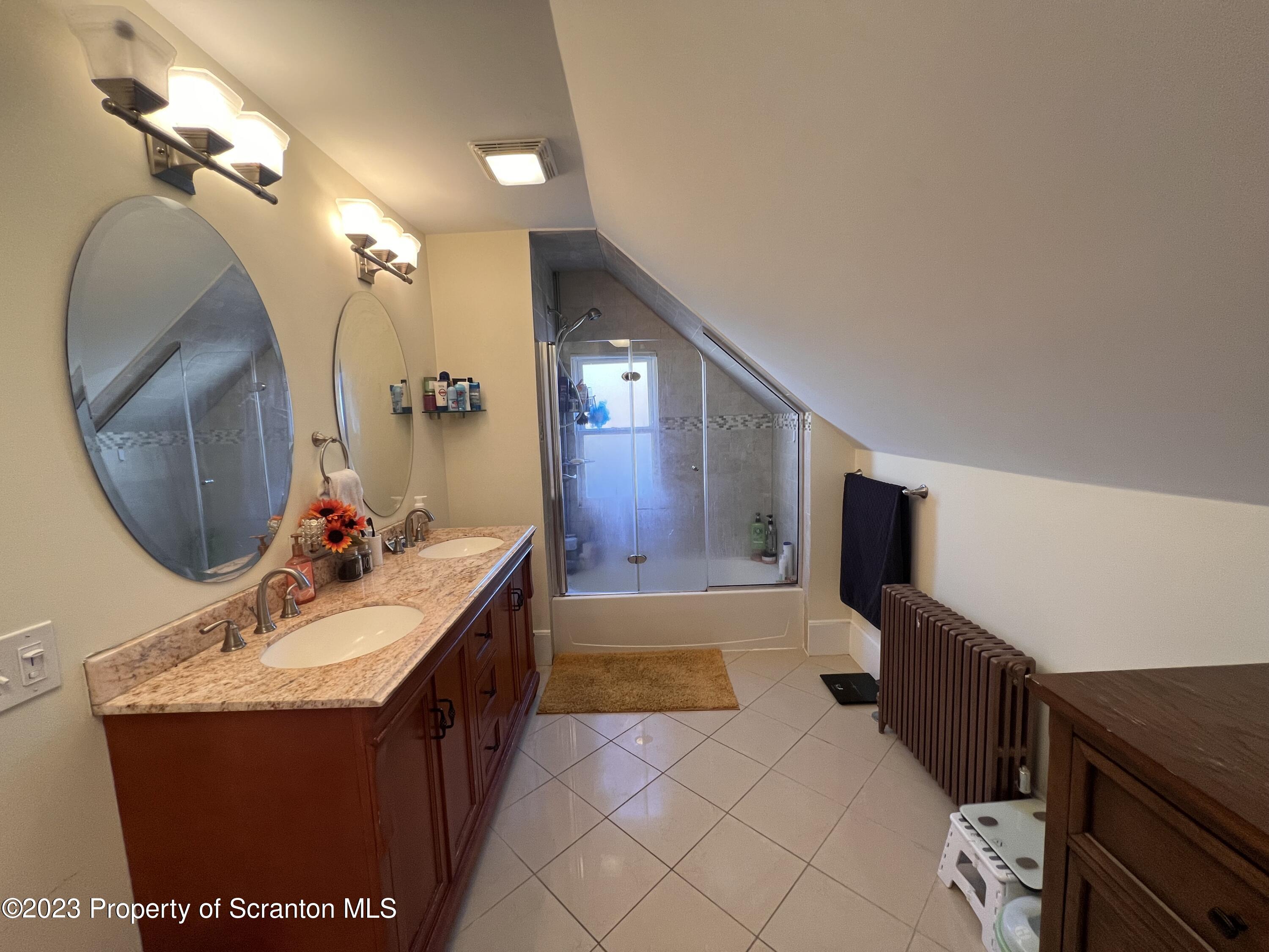 611 East Locust Street Scranton, PA 18505 - Photo 16 of 18 a bathroom with a sink vanity and mirror