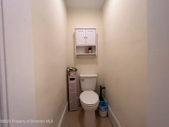 a white toilet sitting next to a shower