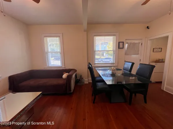 a work room with furniture wooden floor and a window
