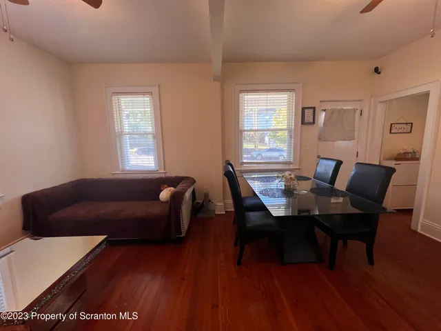 a work room with furniture wooden floor and a window