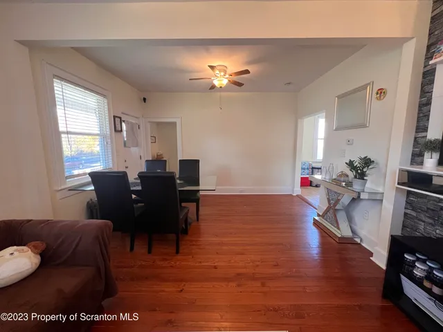 a living room with furniture a dining table and a fireplace