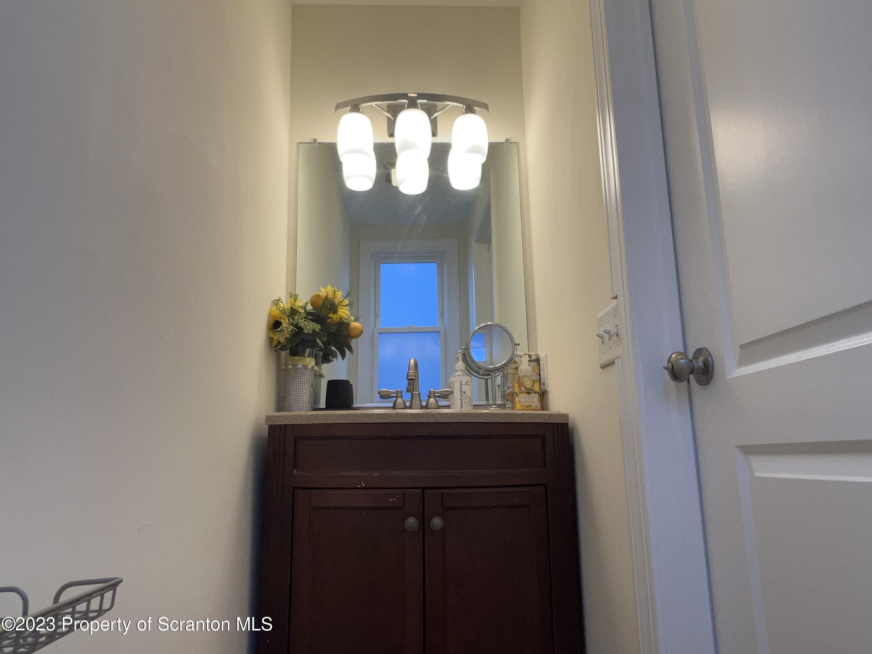 611 East Locust Street Scranton, PA 18505 - Photo 10 of 18 a bathroom with a sink and a mirror
