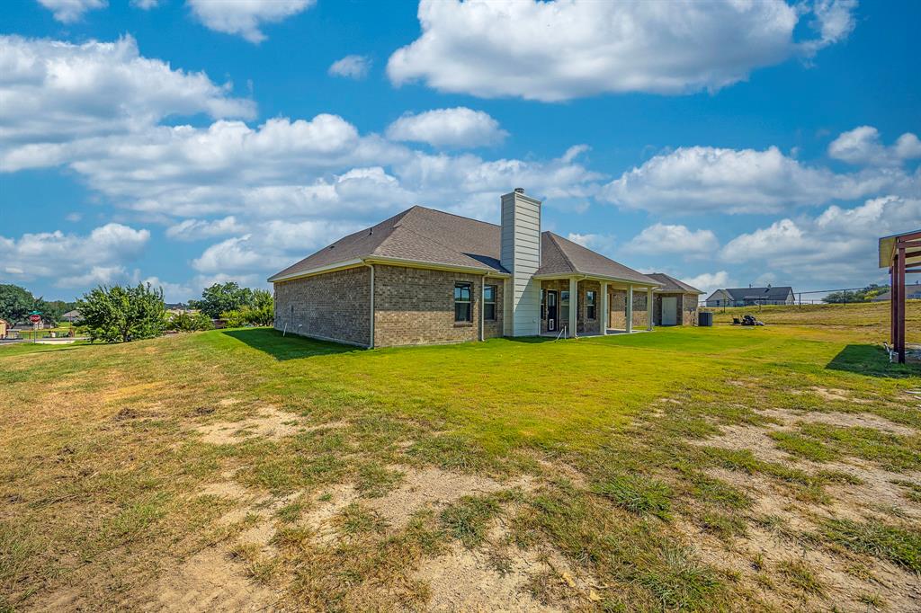 105 Kathy Stephens Avenue Springtown, TX 76082 - Photo 12 of 40 a front view of house with an outdoor space and balcony