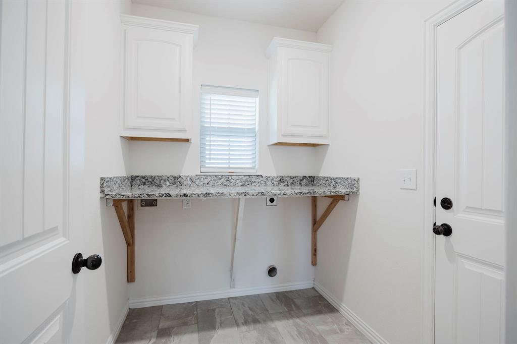 105 Kathy Stephens Avenue Springtown, TX 76082 - Photo 32 of 40 a view of cabinets with granite countertop