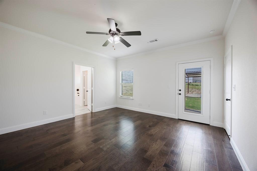 105 Kathy Stephens Avenue Springtown, TX 76082 - Photo 35 of 40 a view of an empty room with wooden floor and a window