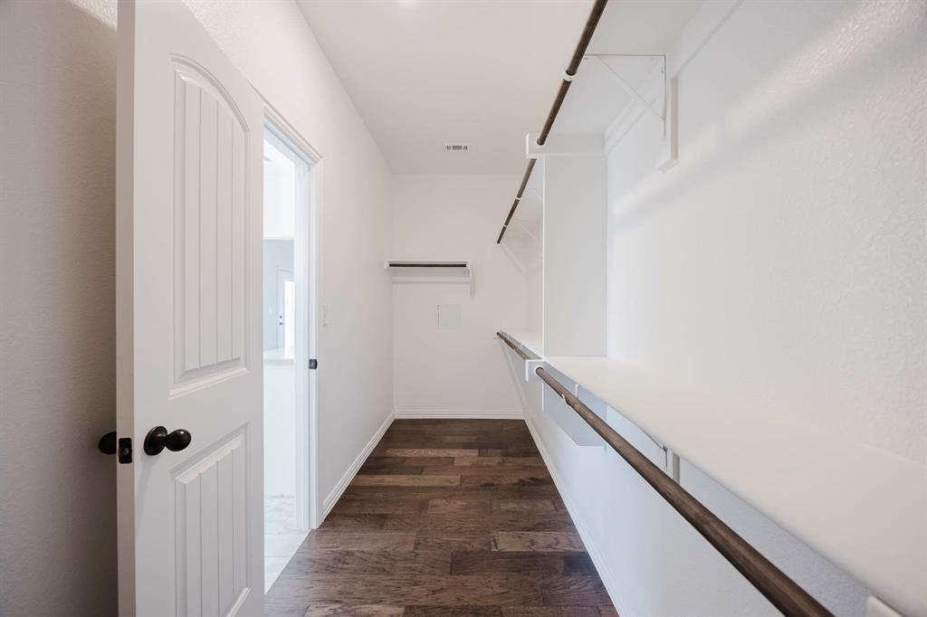105 Kathy Stephens Avenue Springtown, TX 76082 - Photo 38 of 40 a view of a hallway with wooden floor and staircase