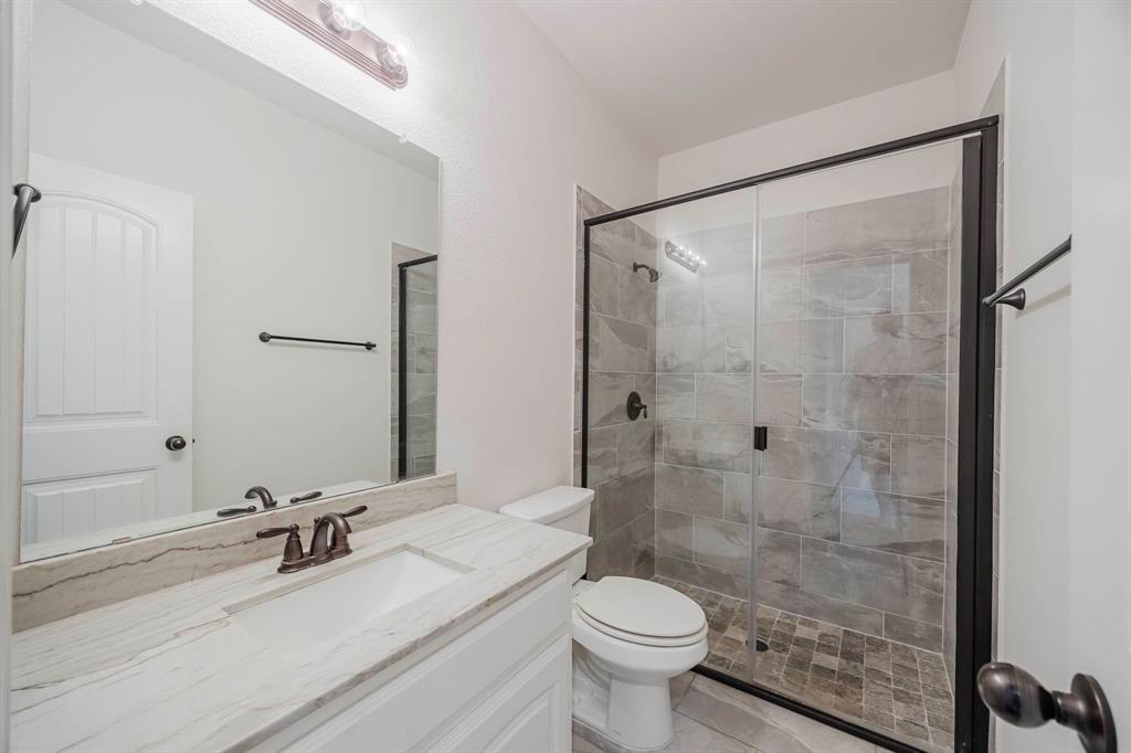 105 Kathy Stephens Avenue Springtown, TX 76082 - Photo 39 of 40 a bathroom with a sink toilet a mirror and shower