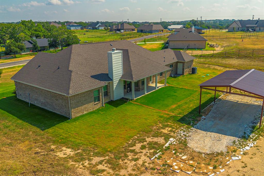 105 Kathy Stephens Avenue Springtown, TX 76082 - Photo 7 of 40 an aerial view of a house with outdoor space and a lake view