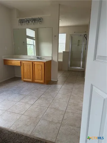 a bathroom with a mirror and a sink