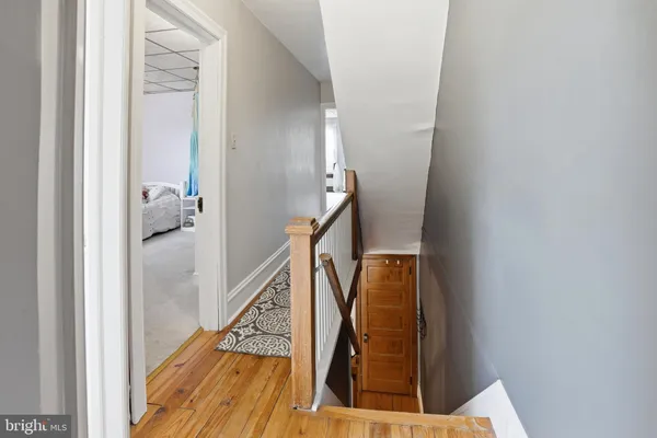 a bedroom with a bed and a flat tv screen on dresser