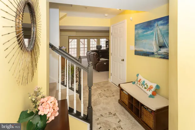 a view of a hallway with wooden floor and stairs