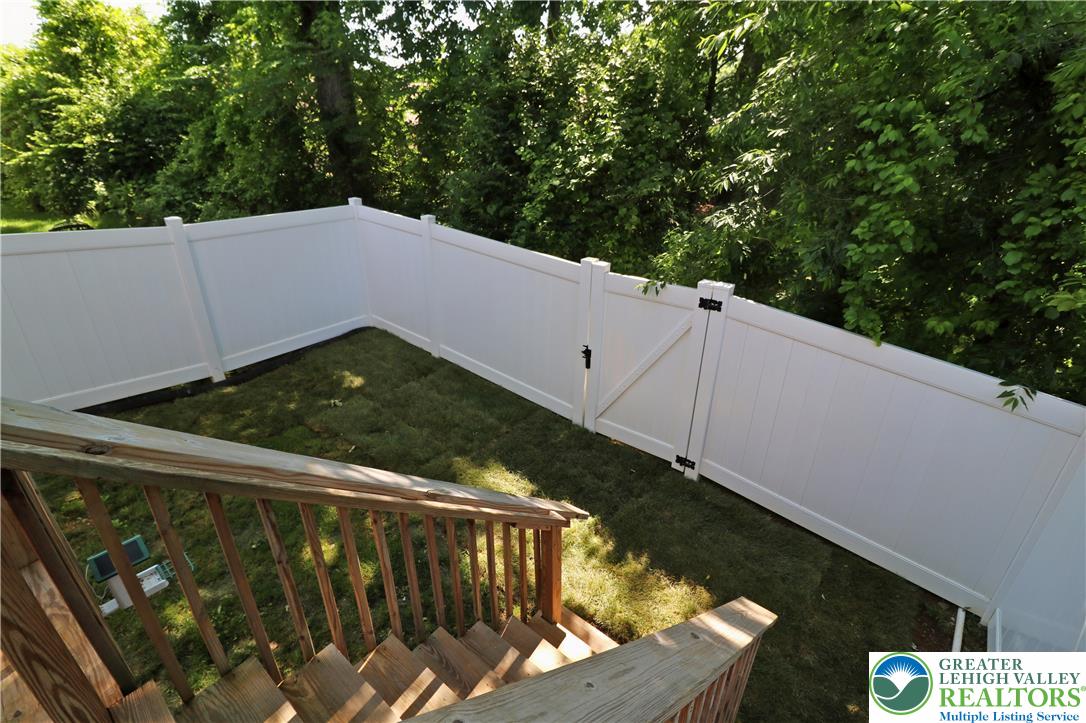 4502 Benjamin Court Emmaus, PA 18049 - Photo 19 of 53 A manicured lawn enclosed by pristine white fencing creates a private outdoor haven.