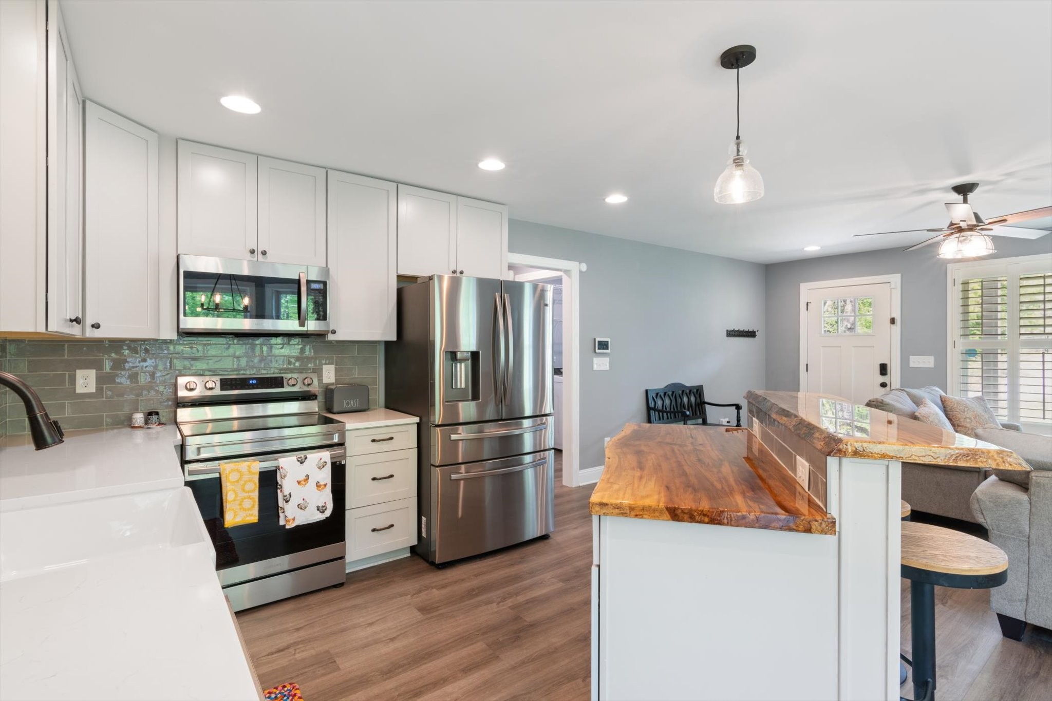 7452 South Swift Road Goodlettsville, TN 37072 - Photo 12 of 27 a kitchen with stainless steel appliances granite countertop a refrigerator a stove a sink and a microwave