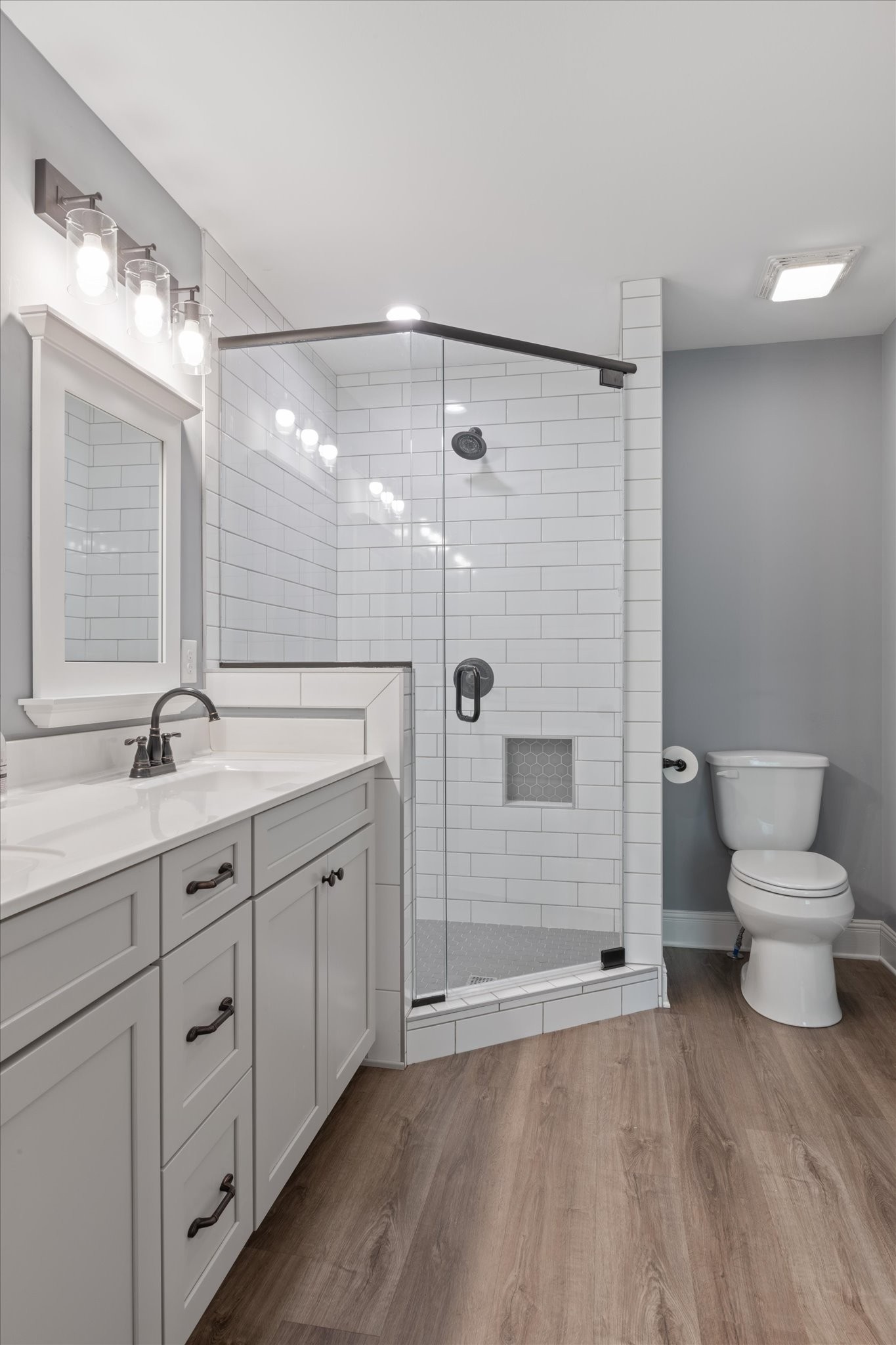 7452 South Swift Road Goodlettsville, TN 37072 - Photo 16 of 27 a bathroom with a double vanity sink a toilet and shower