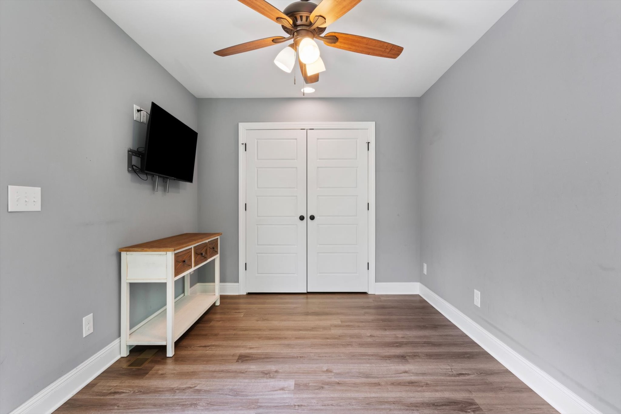 7452 South Swift Road Goodlettsville, TN 37072 - Photo 18 of 27 a view of a livingroom with wooden floor and a ceiling fan