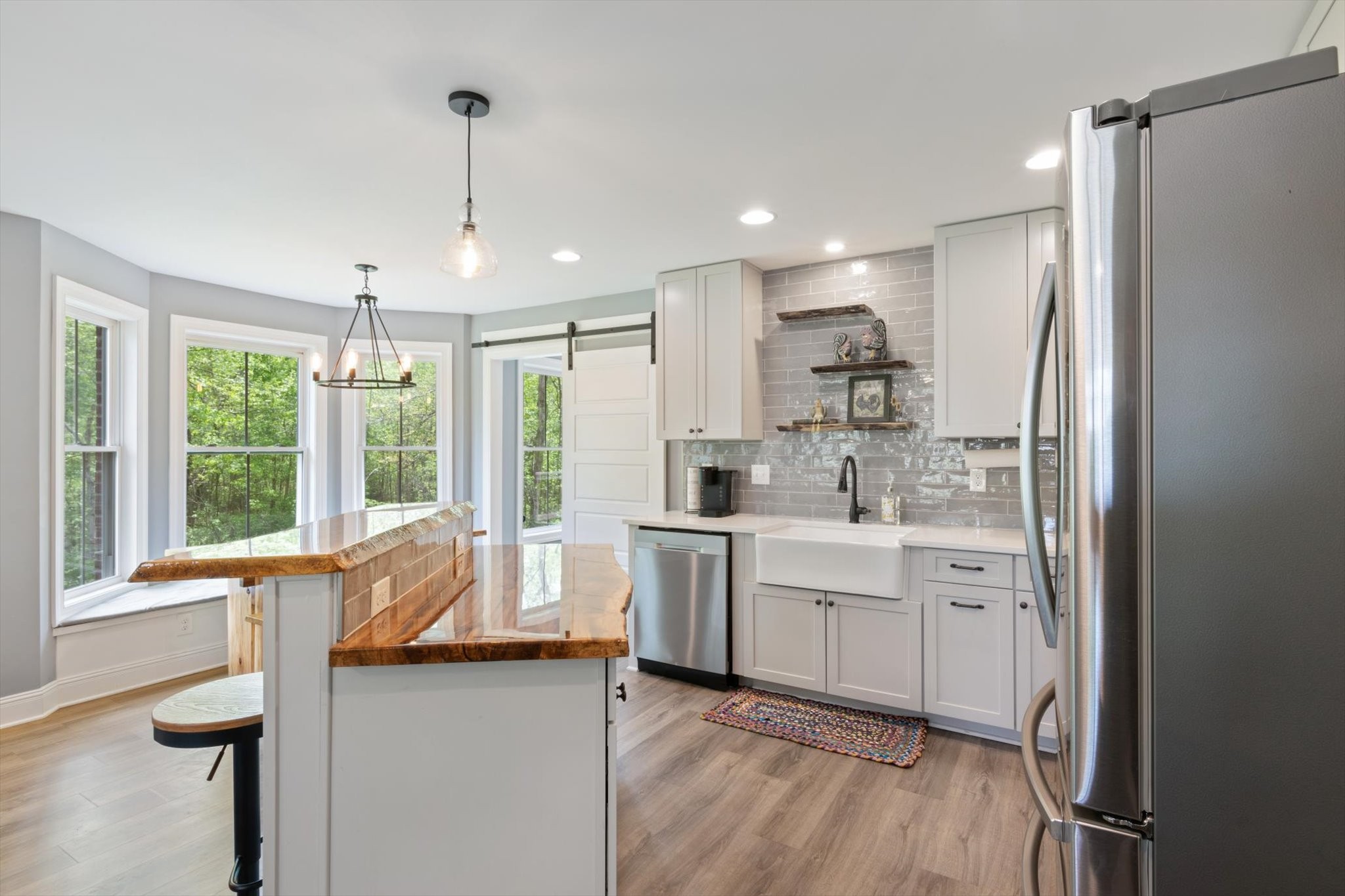 7452 South Swift Road Goodlettsville, TN 37072 - Photo 9 of 27 a kitchen with kitchen island white cabinets and refrigerator