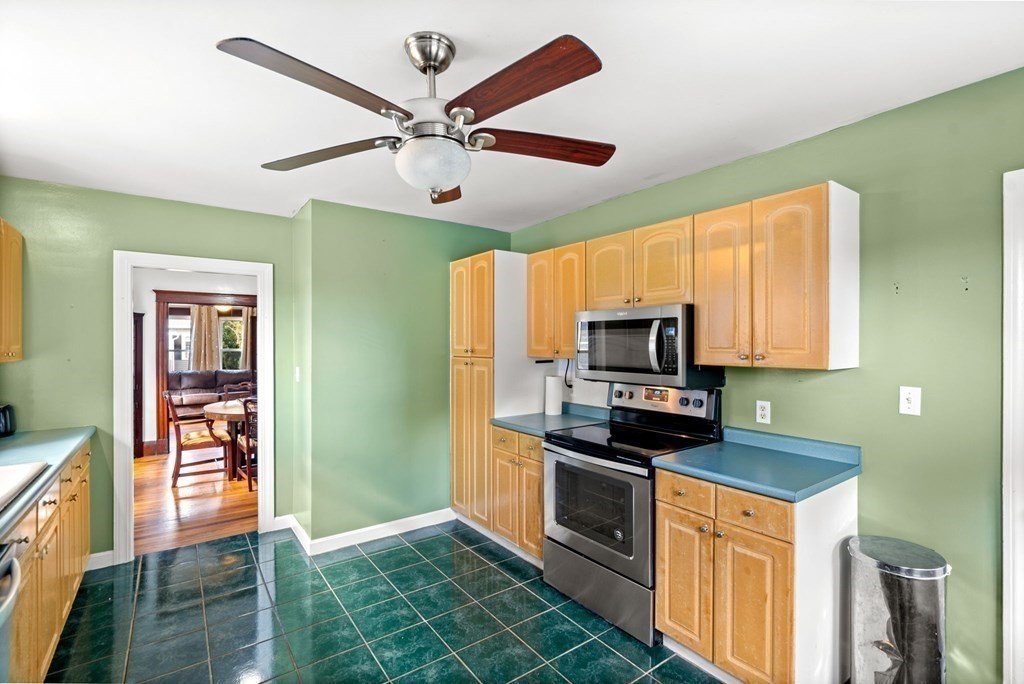14 Fairview Avenue Peabody, MA 01960 - Photo 11 of 37 a kitchen with stainless steel appliances a stove top oven a sink a refrigerator and a microwave