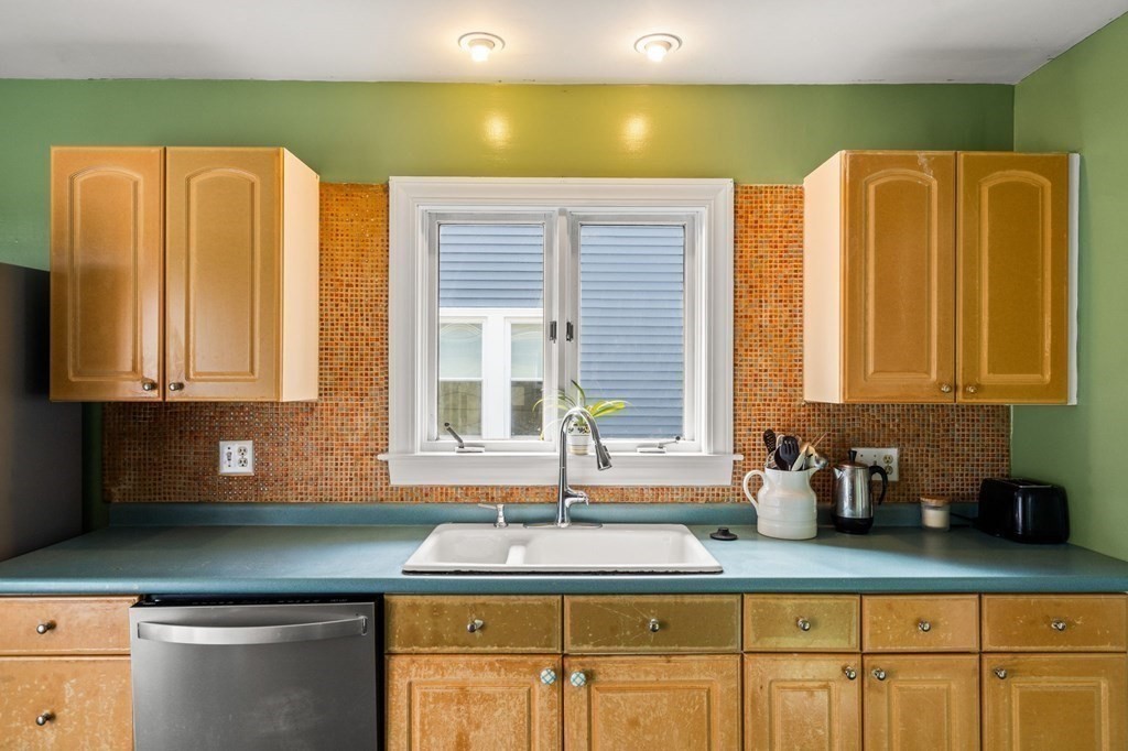 14 Fairview Avenue Peabody, MA 01960 - Photo 12 of 37 a kitchen with stainless steel appliances granite countertop a sink window and cabinets