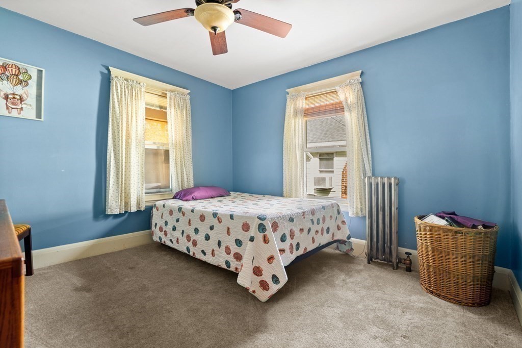 14 Fairview Avenue Peabody, MA 01960 - Photo 20 of 37 a bedroom with a bed and a chandelier