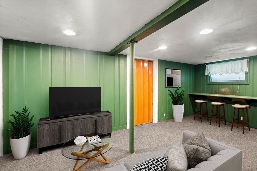 14 Fairview Avenue Peabody, MA 01960 - Photo 26 of 37 a living room with furniture a flat screen tv and a large window