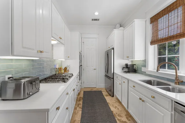 a kitchen with stainless steel appliances granite countertop a sink stove and refrigerator