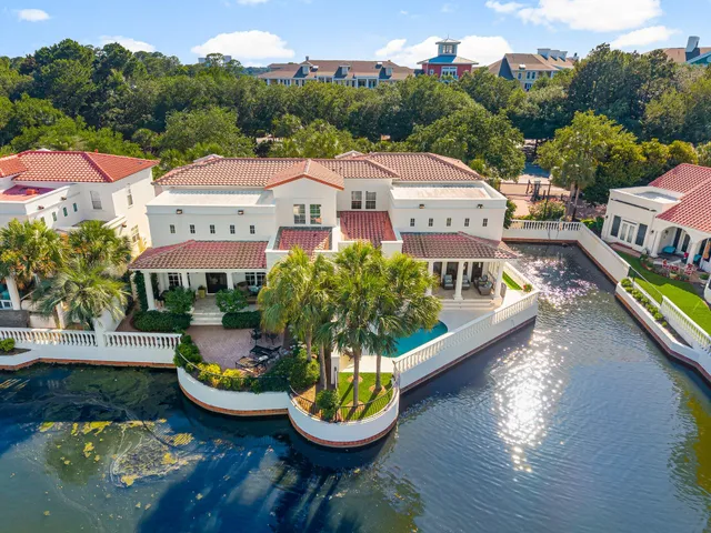 an aerial view of a house with swimming pool and a yard