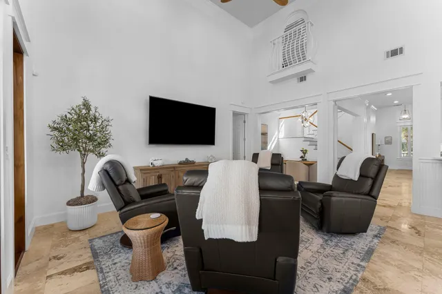 a bedroom with a bed and a flat tv screen on dresser