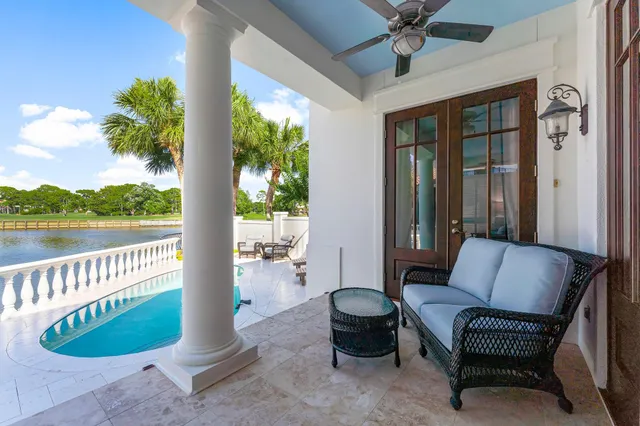 a view of a swimming pool with a patio and a yard