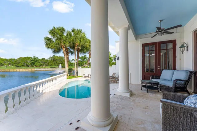 a view of a house with swimming pool and sitting area