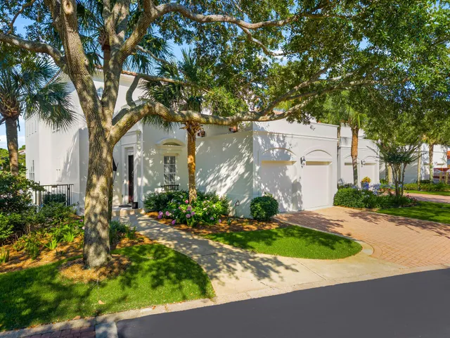 front view of a house with a yard and potted plants