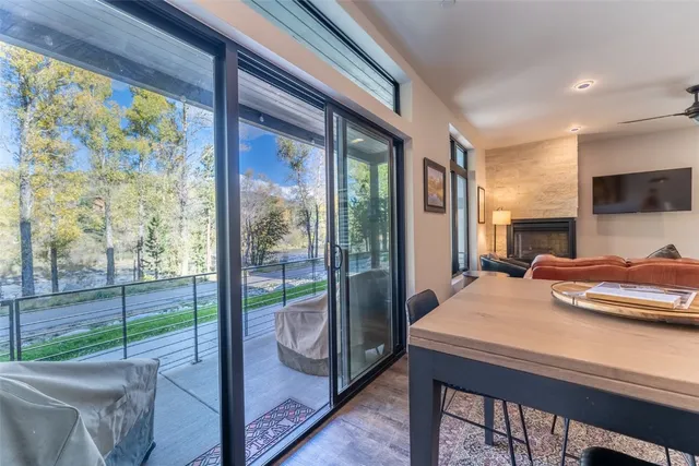 a view of a dining room with furniture a chandelier and wooden floor